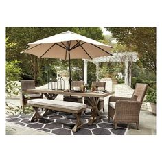 an outdoor dining table with umbrella and chairs