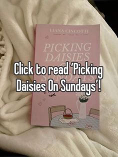 a pink book sitting on top of a bed next to a white blanket with the words picking daisies