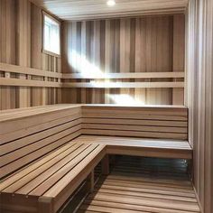 an empty sauna with wooden benches in it