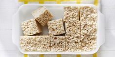 rice krispy treats on a plate with a yellow and white towel in the background