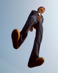 a man is flying through the air with his feet in the air