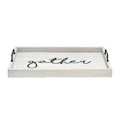 a white tray with black lettering that says gather on the bottom and an oval handle