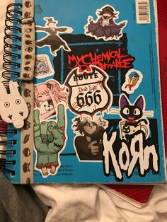 an open notebook with stickers on it