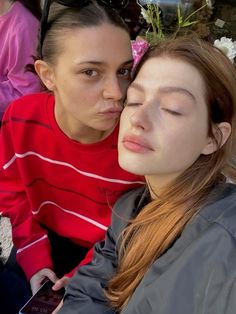 two young women sitting next to each other