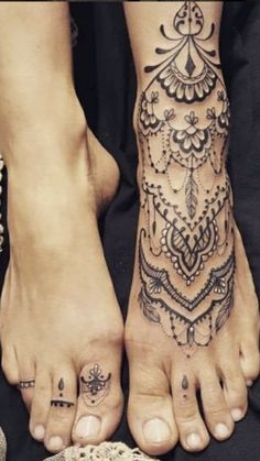 two people with tattoos on their feet and one has a tattoo design on the foot