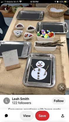 the table is set up with different items for making snowman crafts