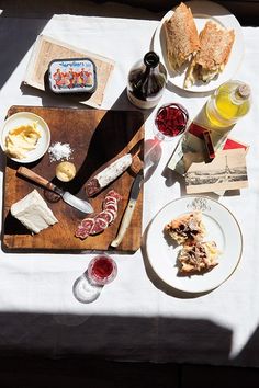 a table topped with plates and bowls filled with food