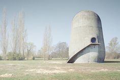 a large concrete structure in the middle of a field