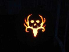 a carved pumpkin with a skull and flames on it