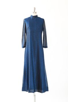 "vintage 1970s metallic blue lurex maxi dress 3/4 semi sheer sleeves High neck fit Zips and ties in back Great vintage condition M e a s u r e m e n t s: Size: fits like a M Bust: 19\" Waist: 17 1/2\" Total length: 56\" Hips: 20 1/2\" Sleeves: 21\" Label: n/a +All Measurements are taking while garment is lying flat+ + Jewelry, belts, and any other accessories are NOT included unless specifically stated in description + i n s t a g r a m: cali_vintage_usa" Flat Jewelry, 1980s Dresses, Gauze Dress, Mexican Dresses, Vintage Usa, Metallic Blue, Sheer Sleeves, Printed Tank Tops, Beaded Dress