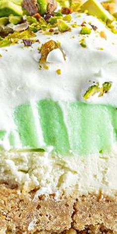 a close up of a piece of cake with white frosting and green leaves on it