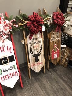 three wooden signs with christmas decorations on them