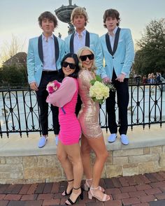 three young people posing for a photo in front of a fountain