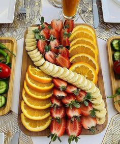 there are many fruits and vegetables on the trays next to each other, including strawberries