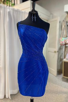 Fancyvestido this tight short royal blue homecoming dress features a one-shoulder with straps, a fitted bodice adorned with beads, and a zipper back. ♡ SKU: FV11782♡ Fabric: Satin♡ Size: US 2-16. True to the size chart. Check our Size Chart to get your correct size.♡ Besides stand sizes 2-16, we still offer free custom sizes. You can email me your specific size, before or after your order.Which requires the following measurements:Bust:___ inch/cmWaist:___ inch/cmHips:___ inch/cmHollow to Hem___i Blue One-shoulder Mini Dress For Prom, Blue Fitted One Shoulder Prom Dress, Blue Fitted One-shoulder Prom Dress, Royal Blue Evening Dress For Homecoming, Blue One Shoulder Sleeveless Dress For Prom, Blue One Shoulder Dress For Prom, Blue One-shoulder Dress For Prom, Blue Evening Dress For Prom With Asymmetrical Neckline, Formal Blue One Shoulder Dress For Prom