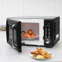 there is a plate with croissants in the microwave