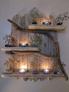 three wooden shelves with lit candles on them