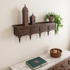 a table with a book, potted plant and other items on top of it