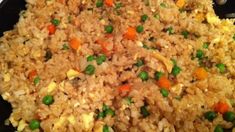 rice with peas and carrots in a skillet ready to be cooked for dinner