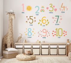 a child's room with a giraffe and numbers on the wall