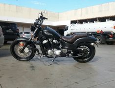 a black motorcycle parked in a parking lot