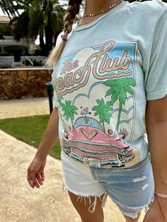 This Lotus Boyfriend Graphic Tee is the perfect laid-back look. Loose in all the right places, its open neckline and slightly dropped sleeves make it ideal for your beach days. With a Mineral Wash and a hand-drawn exclusive graphic, this tee is sure to be your new summer fave! Go get 'em, beach babe! Color: Mint or Light Pink Fabric: 100% Cotton Brand: Lotus Fashion Collection Made: El Salvador Includes: x1 Graphic T-Shirt Sizes: S-XL, Regular Sizing L And Light, Beach Babe, Pink Fabric, Beach Club, Beach Day, Shirt Price, Fashion Collection, Light Pink, Graphic Tshirt