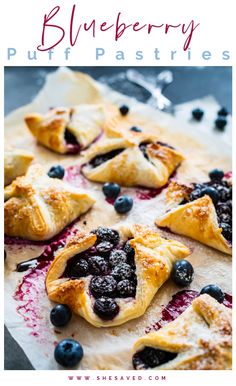 blueberry puff pastries on parchment paper with berries