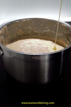 a pot filled with liquid on top of a stove