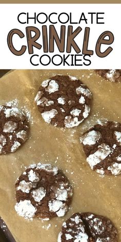 chocolate crinkle cookies on a cookie sheet with powdered sugar in the middle