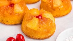 pineapple upside down cakes with cherries on the side