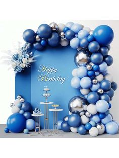 a blue and white birthday party with balloons