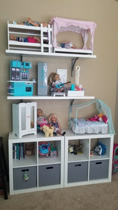 there are many toys on the shelves in this playroom, including dolls and bookshelves