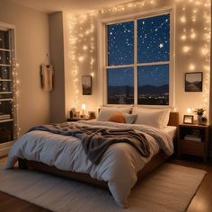 a bedroom with lights on the wall and a large bed in front of a window