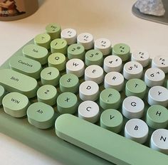 a green and white keyboard sitting on top of a table