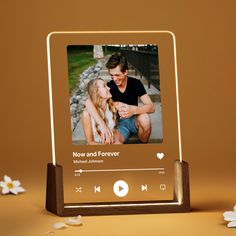 an image of a man and woman sharing a kiss on the screen of a music player