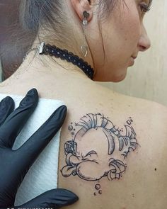 a woman with a tattoo on her shoulder