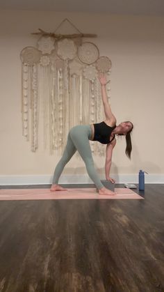 a woman is doing yoga on the floor