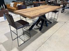 a table and chairs are on display at a furniture store