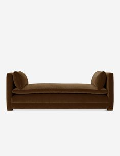 a brown couch sitting on top of a white wall