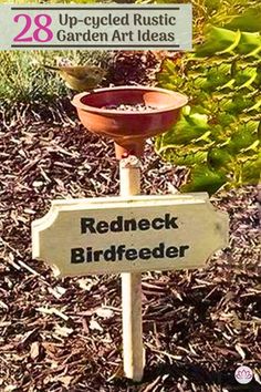 a bird feeder sitting on top of a wooden sign in the middle of some grass