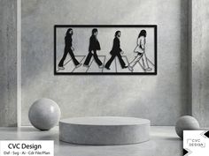 a group of people walking down a street in the same direction, framed on a wall