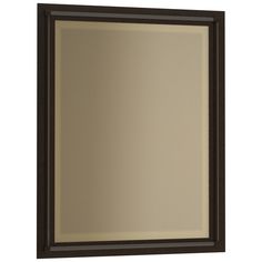 a brown framed mirror on a white wall