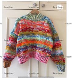 a colorful sweater hanging on a door with the words written in english and an image of it