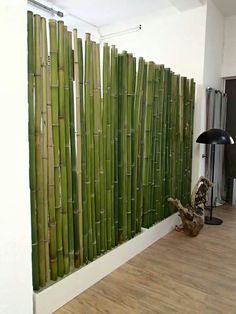 a room that has some kind of bamboo fence on the wall in front of it