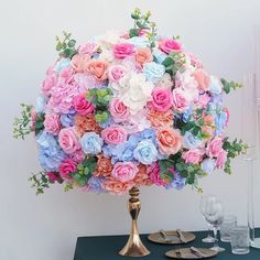 a large bouquet of pink and blue flowers on a table