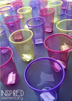 purple and yellow cups are lined up on a table with the words, inspired elementary