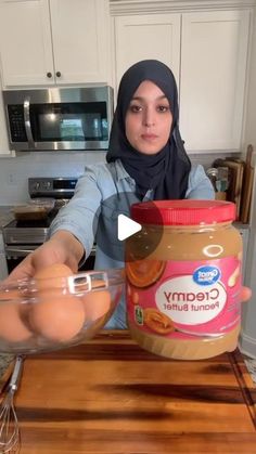 a woman in a hijab is mixing ingredients for an ice cream recipe on a kitchen counter