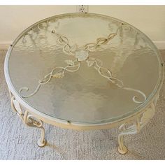 a round glass table sitting on top of a carpeted floor