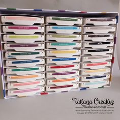 an organized drawer with many different colored labels on the bottom and bottom drawers in it