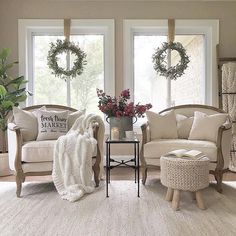 the living room is decorated with wreaths and holiday decorations on the windows sill